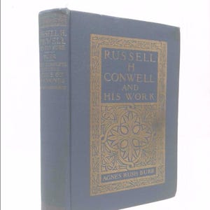 May include: A hardcover book titled "RUSSELL H. CONWELL AND HIS WORK" by Agnes Rush Burr. The book has a dark blue cover with gold lettering and decorative border. The spine also features text.