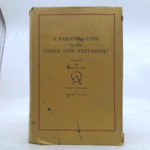 May include: A vintage book titled "A Parsing Guide to the Greek New Testament." The cover is a faded yellow with a red border and text in black. The book is compiled by Nathan E. Han and has an introduction by Merrill C. Tenney.
