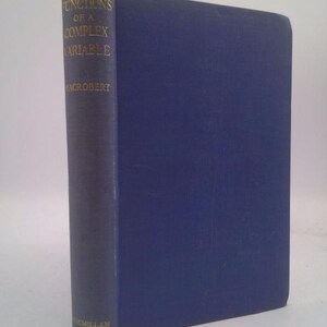 May include: A hardcover book titled "Functions of a Complex Variable" by MacRobert. The book has a dark blue cover and spine with gold lettering. The publisher's name, Macmillan, is printed at the bottom of the spine.