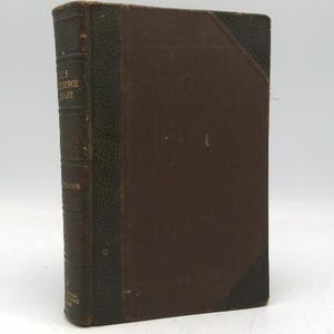 May include: An antique hardcover book with a brown cover and a dark green spine. The spine has embossed text and the corners are reinforced with dark green leather. The book is likely a vintage edition.