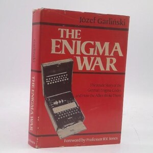 May include: A red book titled "The Enigma War" by Józef Garliński, featuring an illustration of an Enigma machine. The book cover includes the text "The inside story of the German Enigma Codes and How the Allies Broke Them."