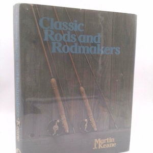 May include: A book titled "Classic Rods and Rodmakers" by Martin J. Keane. The cover features a wood-paneled background with three vintage fishing rods and reels.