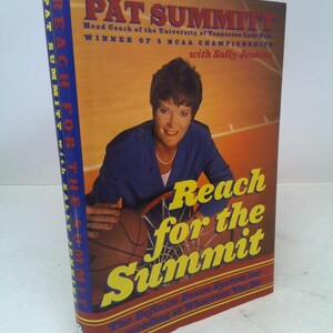 May include: A hardcover book titled "Reach for the Summit" by Pat Summitt. The cover features a photo of Pat Summitt, a basketball, and the book's title in large yellow letters. The book's spine is blue.