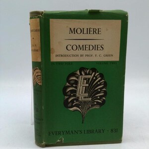 May include: A green book titled "Molière Comedies" from Everyman's Library, Volume Two. The cover features the title in white, with a decorative emblem and the number 831. The spine of the book is visible, showing the title and author.