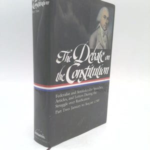 May include: A hardcover book titled "The Debate on the Constitution." The cover is dark with a portrait of a man in a white wig. The title is in elegant script, with the subtitle "Federalist and Antifederalist Speeches, Articles, and Letters During the Struggle over Ratification."