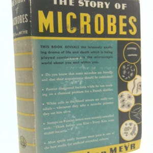 May include: Vintage book titled "The Story of Microbes" by Berl ben Meyr. The cover is black with yellow lettering, and a teal panel with white text. The book's spine is light green with gold horizontal lines. The book is a vintage science book.