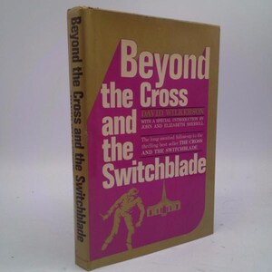 May include: A gold and pink book cover with the title "Beyond the Cross and the Switchblade" by David Wilkerson. The cover features a silhouette of a person holding a switchblade in front of a church.