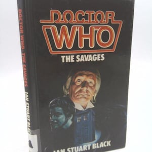 May include: A Doctor Who paperback book cover featuring the Fourth Doctor, Tom Baker, with the title "Doctor Who: The Savages" by Ian Stuart Black.