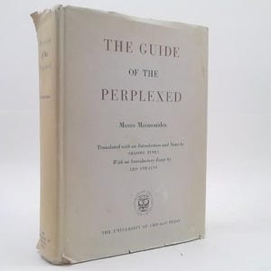 May include: A hardcover book titled The Guide of the Perplexed by Moses Maimonides, translated by Shlomo Pines with an essay by Leo Strauss. The cover is off-white with dark grey text and a small circular logo near the bottom, published by The University of Chicago Press.