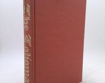 May include: A red hardcover book with the title "The Talisman" by Sir Walter Scott printed in gold lettering on the spine.