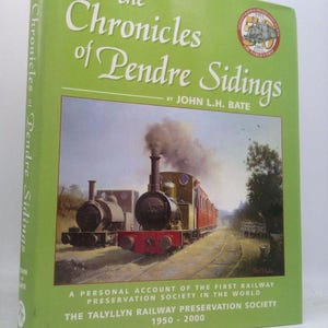 May include: A hardcover book titled "The Chronicles of Pendre Sidings" by John L.H. Bate. The cover is green with white text and a painting of a steam train. The book is about the Talyllyn Railway Preservation Society.