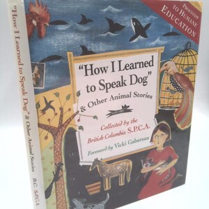 May include: A hardcover book titled How I Learned to Speak Dog & Other Animal Stories, collected by the British Columbia S.P.C.A. The cover features colorful illustrations of a rooster, whales, a bird in a cage, a horse, and a person holding a cat.