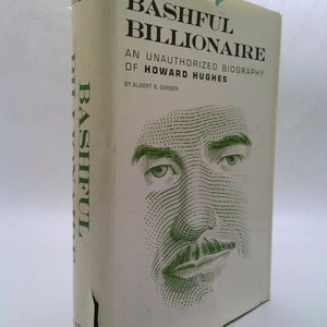 May include: A white book cover with green text that reads "Bashful Billionaire: An Unauthorized Biography of Howard Hughes by Albert B. Gerber". A green and white halftone image of a man's face is on the cover.