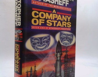 May include: A book cover with a red, orange, and purple background. The title is "A Company of Stars" by Christopher Stasheff. The book is part of the "Starship Troopers" series.