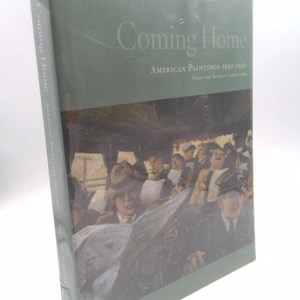 May include: A green hardcover book titled "Coming Home: American Paintings 1930-1950" with a painting of people on a bus on the cover. The painting shows a group of people sitting on a bus, with one man reading a newspaper.