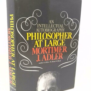 May include: A black book cover with white text that reads "Philosopher at Large" by Mortimer J. Adler, author of "How To Read A Book".
