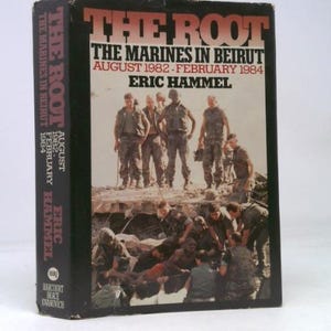 May include: A hardcover book titled "THE ROOT: The Marines in Beirut" by Eric Hammel. The cover features a photograph of U.S. Marines in uniform. The book's spine displays the title, author, and publication details.