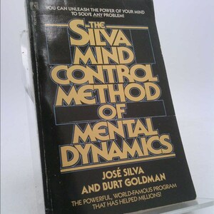 May include: A black and gold book titled "The Silva Mind Control Method of Mental Dynamics" by José Silva and Burt Goldman. The book cover features the title in large, bold letters and includes the tagline "The powerful, world-famous program that has helped millions!"