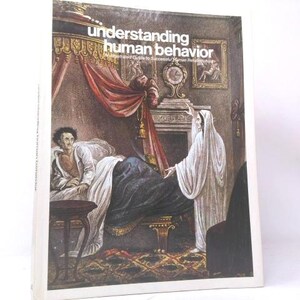May include: A hardcover book titled Understanding Human Behavior: An Illustrated Guide to Successful Human Relationships. The cover features a vintage-style illustration of a person in bed being visited by a cloaked figure in a room with red curtains.