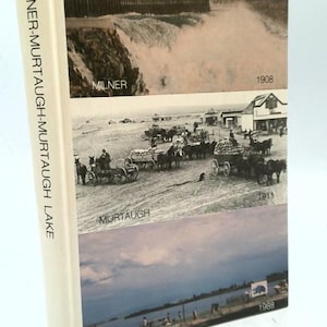 May include: A hardcover book titled "Milner-Murtaugh-Murtaugh Lake." The cover features three historical images: a dam, horse-drawn carriages, and a lake scene. The book's spine displays the title vertically.