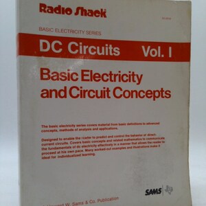 May include: A white book with red text titled "DC Circuits Vol. I Basic Electricity and Circuit Concepts" by Radio Shack. The book is part of the Basic Electricity Series and is a Howard W. Sams & Co. Publication.