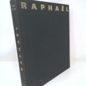 May include: A black hardcover book with the title "RAPHAEL" printed in gold letters on the spine and front cover.