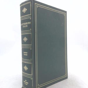 May include: A dark green hardcover book titled The Canterbury Tales by Geoffrey Chaucer. The spine features gold lettering and decorative filigree patterns, with gold-lined borders on the front cover and spine, part of The Franklin Library collection.