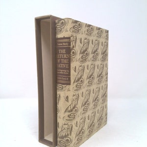 May include: A brown hardback book with a beige cover featuring a repeating pattern of snakes and trees. The title "The Return of the Native" by Thomas Hardy is printed on the spine.