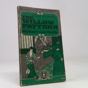 May include: Vintage paperback book titled "The Willow Pattern" by Robert van Gulik. The cover features a green and white illustration of a scene with figures in robes. The book has a worn appearance.