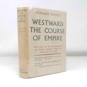 May include: A hardcover book titled "Westward the Course of Empire" by Bernard DeVoto. The book's cover is a light beige color with black text. The title and author's name are prominently displayed. The book is wrapped in clear plastic.