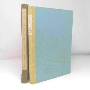 May include: Two vintage books are displayed. The book on the left has a brown cover with text. The book on the right has a light blue cover with gold lines and a floral design. The spine is a light tan color.