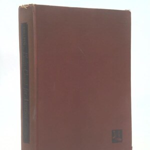May include: A hardcover book with a brown cover. The spine is dark brown with white text that reads "Chapin, Plant Clinic for Americans". The book has a small black emblem on the lower right corner.