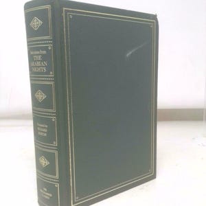 May include: A hardcover book titled "Selections from The Arabian Nights" with a dark green cover and gold lettering. The book is part of "The World's Classics" series and features decorative gold accents.