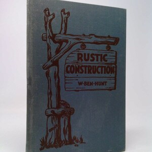 May include: A blue book cover with a brown illustration of a wooden sign that reads "RUSTIC CONSTRUCTION W-BEN-HUNT".