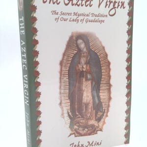 May include: A hardcover book titled "The Aztec Virgin" with a depiction of a religious figure. The cover features the text "The Secret Mystical Tradition of Our Lady of Guadalupe" and the author's name, John Mini.