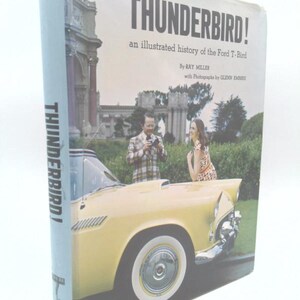 May include: A hardcover book titled THUNDERBIRD! an illustrated history of the Ford T-Bird by Ray Miller with photographs by Glenn Embree. The cover features a yellow vintage Ford Thunderbird car, a person in a plaid jacket, and a person in a dress.