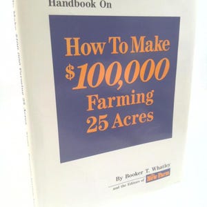 May include: A hardcover book titled "How To Make $100,000 Farming 25 Acres" by Booker T. Whatley. The book cover is off-white with a dark blue rectangle containing orange text. The book is a guide to farming.