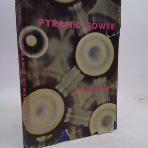 May include: A book titled "Pyramid Power" by Pat Flanagan with a black and white cover featuring a series of overlapping circles with a yellow and blue center.