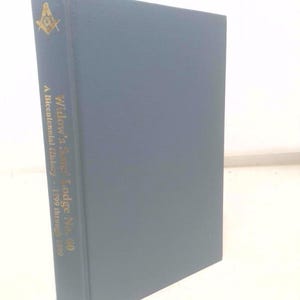 May include: A blue hardcover book titled "Widow's Sons' Lodge No. 60" with gold lettering and a Masonic symbol. The book is a bicentennial history from 1799 through 1999, published by Simpson.