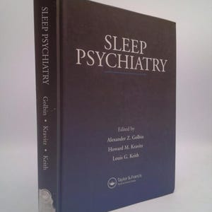 May include: A dark blue book titled "Sleep Psychiatry" with the names of the editors, Alexander Z. Golbin, Howard M. Kravitz, and Louis G. Keith, printed on the cover. The book is published by Taylor & Francis.