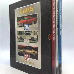 May include: A black box set of three books titled "Cars of the Fabulous '50s", "Cars of the Sizzling '60s", and "Cars of the Sensational '70s". The box set features a collector's edition label and images of cars from each decade.