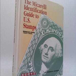 May include: A vintage book titled "The Micarelli Identification Guide to U.S. Stamps." The cover features a green and white illustration of a U.S. stamp with George Washington. The book's spine displays the title and author.