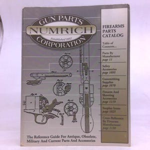 May include: A gray Numrich Gun Parts Corporation firearms parts catalog featuring technical line drawings of revolver components and a vertical firearm illustration. The cover includes a table of contents and the text The Reference Guide For Antique, Obsolete, Military And Current Parts And Accessories.