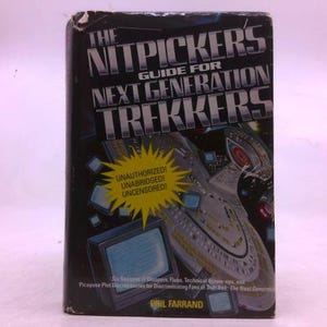 May include: A book titled "The Nitpickers Guide for Next Generation Trekkers" with a black cover. The cover features a starship illustration and text in silver and white. A yellow burst shape contains the words "Unauthorized! Unabridged! Uncensored!"