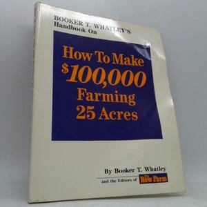 May include: A hardcover book titled "How To Make $100,000 Farming 25 Acres" by Booker T. Whatley. The book has a white cover with a blue square containing orange text. The book is part of the "Handbook On" series.