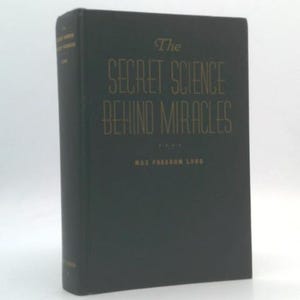 May include: A hardcover book titled "The Secret Science Behind Miracles" by Max Freedom Long. The book has a dark cover with gold lettering. The book is standing upright.