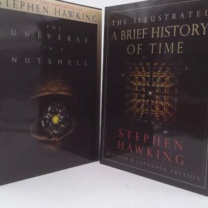 May include: Two hardcover books by Stephen Hawking. The left book is titled The Universe in a Nutshell with a walnut graphic. The right book is titled The Illustrated A Brief History of Time, Updated & Expanded Edition, featuring a grid graphic.