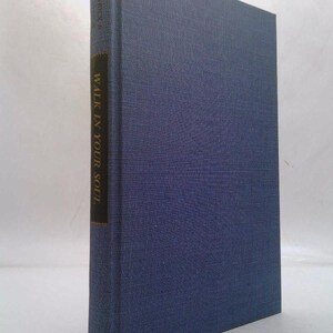 May include: A hardcover book with a textured, dark blue cover. The spine features the title "WALK IN YOUR SOUL" in white text on a dark band. The book's overall aesthetic suggests a classic or literary theme.