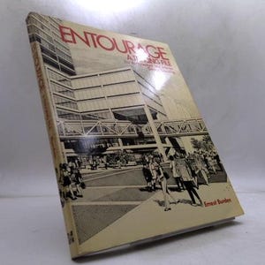 May include: A vintage book titled "ENTOURAGE A TRACING FILE" with a beige cover. The cover features a black and white illustration of a modern building and people. The author's name, Ernest Burden, is printed at the bottom.