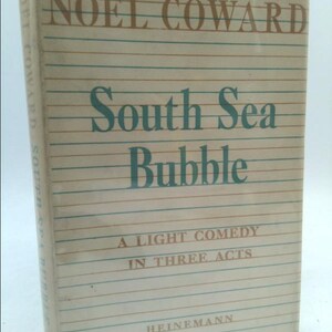 May include: A book cover with a white background and blue and brown lines. The title is "NOËL COWARD South Sea Bubble" in brown and green text. The subtitle is "A LIGHT COMEDY IN THREE ACTS" in brown text. The publisher is "HEINEMANN" in brown text.